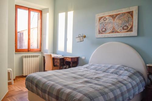 a bedroom with a bed with a plaid blanket at Penthouse Angelo Brunetti in Rome