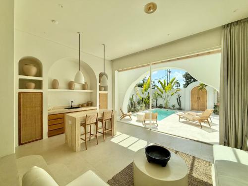 a kitchen and living room with a view of a pool at Dolce Suites in Uluwatu