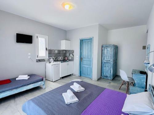 a bedroom with a bed and a sink and a kitchen at Doma by Kristina in Chrysi Ammoudia