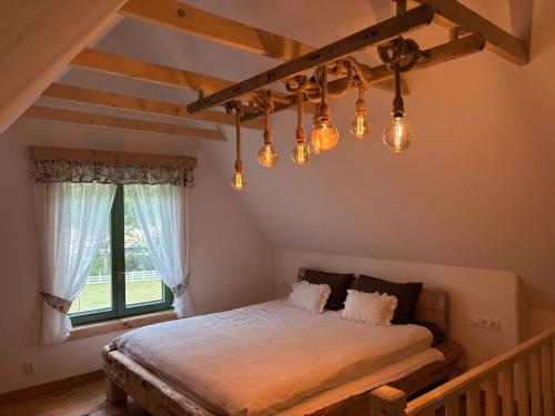 a bedroom with a bed with lights on it at Pompei Village in Cojocani