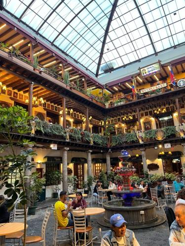 a large building with people sitting at tables in it at Hostal Marín Central - Quito in Quito