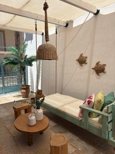 a room with a bed in a room with a table at Kalomoira's Apartments in Elafonisos