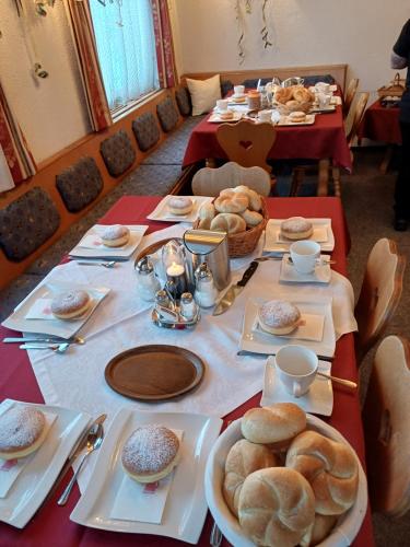 a long table with plates of bread on it at Haus zur Linde in Wagrain