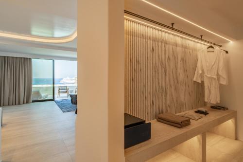 a dressing room with a white shirt hanging on a wall at Tagoo Hills in Mikonos
