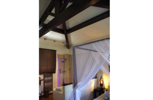 a bedroom with a bed with white curtains on it at B&B Val D'azur in Carqueiranne
