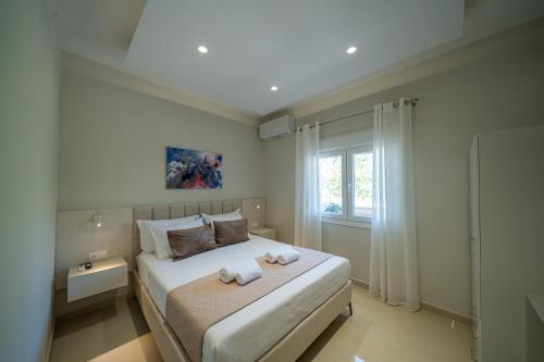 a bedroom with a large bed with towels on it at Gerania nature Residence 22 in Siátista