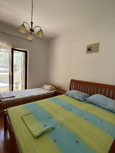 a bedroom with two beds and a window at Apartments Vukasović in Kotor