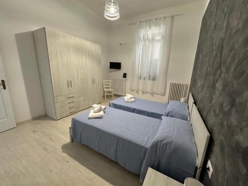 a bedroom with two beds and a tv at Casa Pinuccio Sapri in Sapri