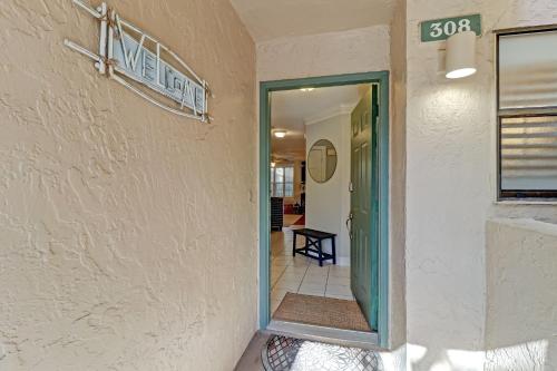 a door to a hallway with a sign on a wall at 308 Sailmaker in Amelia Island