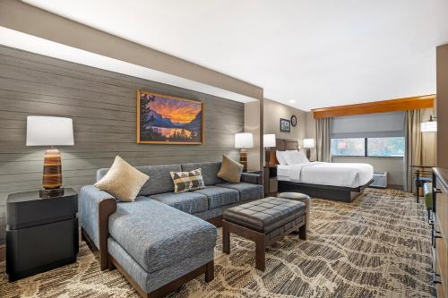 a hotel room with a couch and a bed at Best Western Plus GranTree Inn in Bozeman