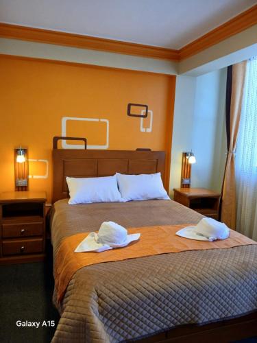 a bedroom with a bed with two towels on it at Qamana Soto S in Uyuni