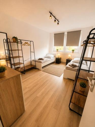 a bedroom with two bunk beds and a living room at Grammendorf Monteur-Apartments in Grammendorf