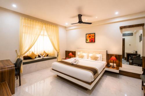 a hotel room with a bed and a desk and a desk at Mount Valley Resort in Kumbhalgarh