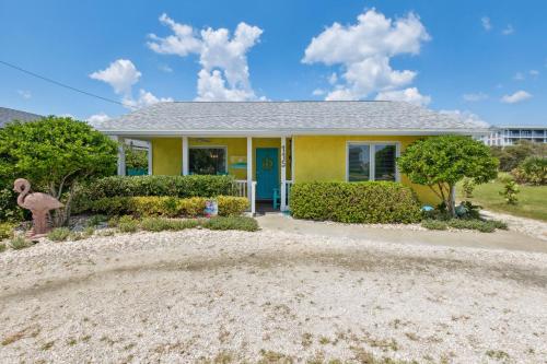 a yellow house with a blue door at 115 South Fletcher in Fernandina Beach