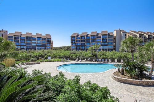 a swimming pool in front of two apartment buildings at 1172 Beach Walker in Amelia Island