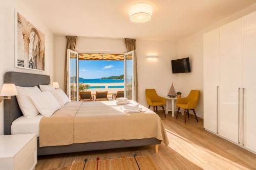 a bedroom with a bed and a view of the ocean at Villa Bilic in Rogoznica