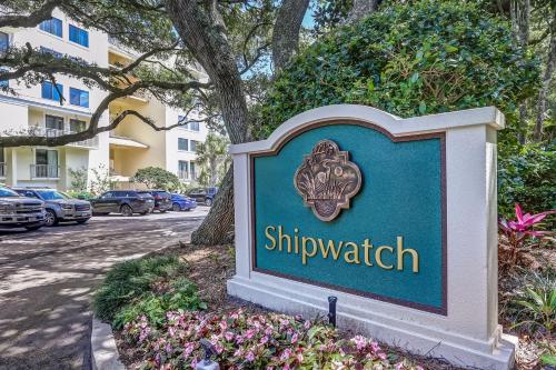 a sign in front of a building with flowers at 1321 Shipwatch in Amelia Island