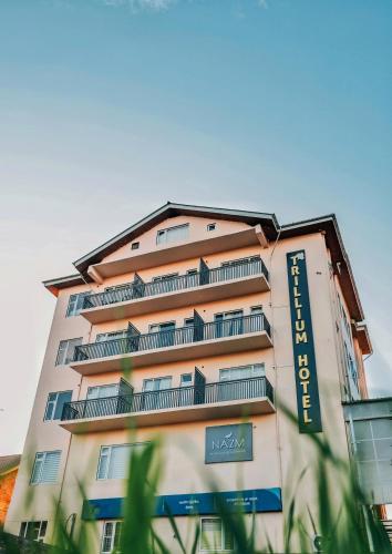 a tall building with a sign on the side of it at Trillium Hotel by Stay Sphere in Srinagar