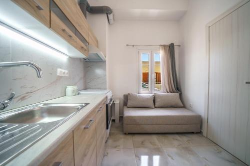 a small kitchen with a sink and a chair at Veniro Luxury Apartments in Moírai