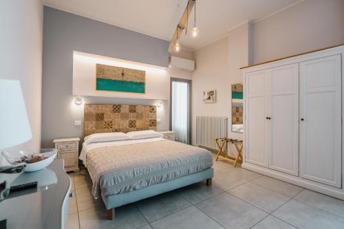 a bedroom with a bed and a white cabinet at Dimora Marinucci in Termoli