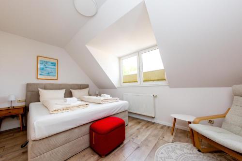 a bedroom with a bed and a desk and a chair at Casa Claudio in Plau am See