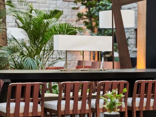 two chairs and a table with a lamp at Swissotel Uludag Bursa in Bursa
