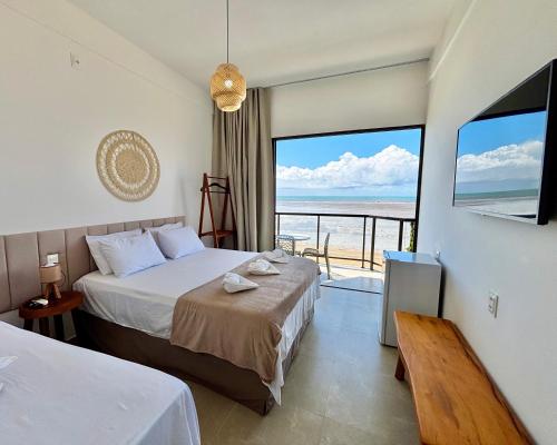 Ένα ή περισσότερα κρεβάτια σε δωμάτιο στο Maraga Bento Hotel