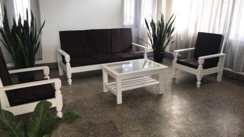a living room with a couch and two chairs at Lighthouse Villa Homestay in Dimapur