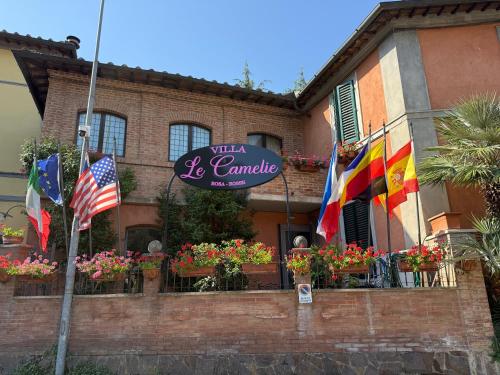 a sign for a restaurant with flags in front of it at Villa Le Camelie Siena in Siena