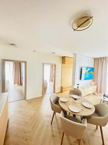 a living room with a table and chairs at J&M apartman in Liptovská Teplá