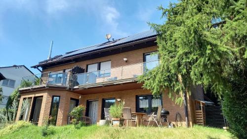 a large brick house with a balcony on it at Ferienwohnungen Nibelungenwald in Mossautal