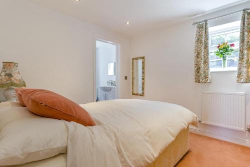 a white bedroom with a large bed and a window at 1 Bed in Halam oc-o32227 in Edingley