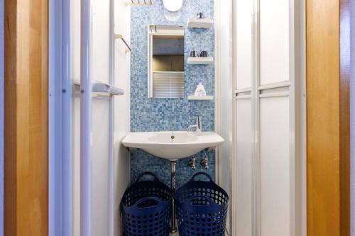 a small bathroom with a sink and a mirror at Kokusai Street Garden Hotel in Naha