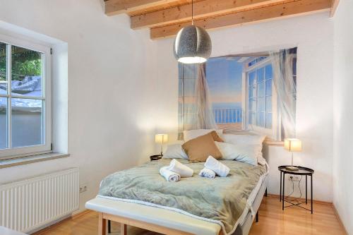a bedroom with a bed with two pillows on it at Charming Lakenear Apartment in Sipplingen