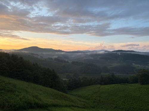 a view of a valley with fog in the hills at Chasing Clouds Cabin in Todd