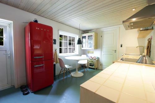 a kitchen with a red refrigerator and a table at id123 Karl Andersensvej 16 in Esbjerg