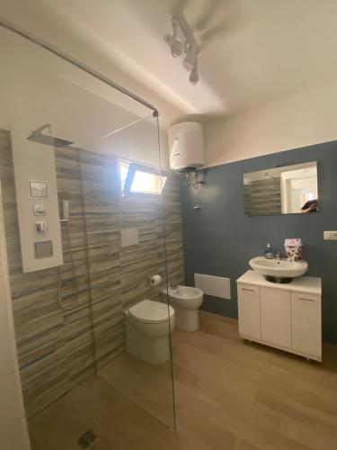 a bathroom with a shower and a toilet and a sink at Leonardo in Veglie