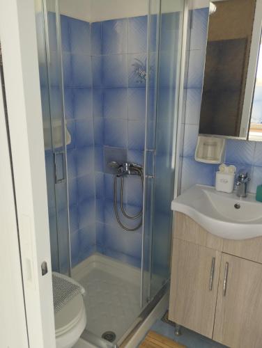 a bathroom with a shower and a sink at Stelios Studios - Zante Seaview Nests in Tragaki