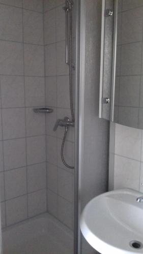 a bathroom with a shower and a sink at Gästehaus Lutschounig in Faak am See