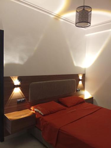 a bedroom with a red bed with lights on it at Cozy two bedroom apartment in Meknès