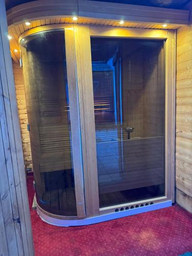 a large glass shower door in a room at Logis Hôtel Le Cairn in Les Deux Alpes