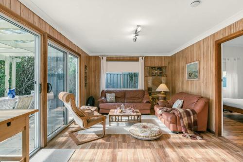 a living room with a couch and a table at Sugar Shack Currarong in Currarong