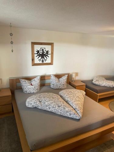 a bedroom with two beds with pillows on them at Apartment Lärchenstube in Mieders