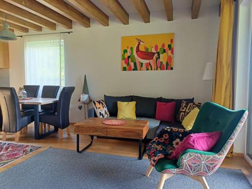 a living room with a couch and a table at Domek w górach Łubinowa 6 in Międzylesie