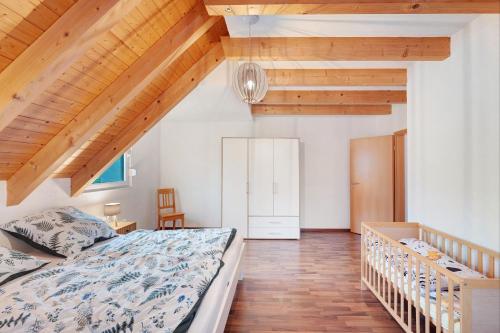 a bedroom with a bed and wooden ceilings at Ferienwohnung Joosenhof in Winden im Elztal