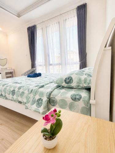 a bedroom with a bed and a potted plant on a table at Noble Cove Batam in Pulau Sembakau Kecil