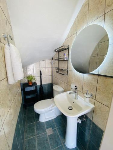 a bathroom with a sink and a toilet and a mirror at Gennadi Escape House in Gennadi