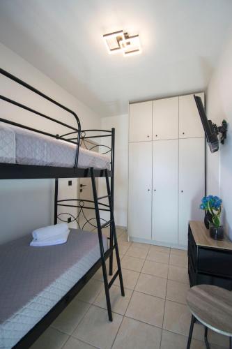 a bedroom with two bunk beds and a desk at Gennadi Escape House in Gennadi