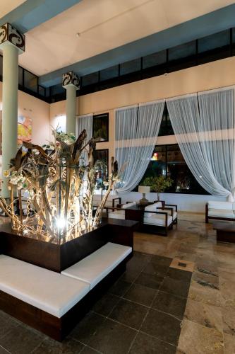 a lobby of a resort with couches and tables at Leo Punta Umbría in Punta Umbría