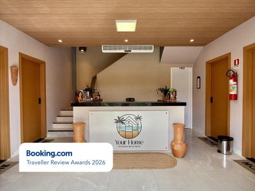 a lobby with a waiting area with a sign on the wall at Your Home - Studios Boutique Hotel in São Luís